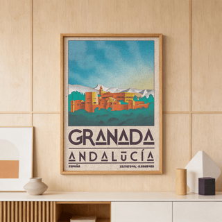 Framed Spanish City Poster of the Alhambra fortress with bright blue sky on a wooden wall above a vase