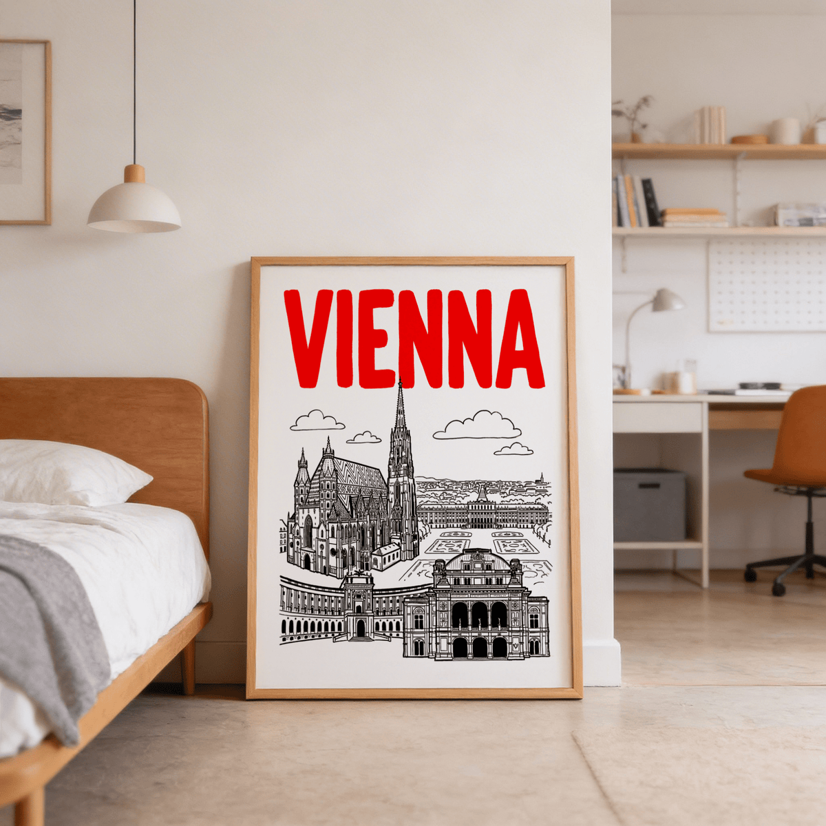 Print leaning on the floor of Vienna Cityscape Print with red text and black line-art landmarks near a wooden bed
