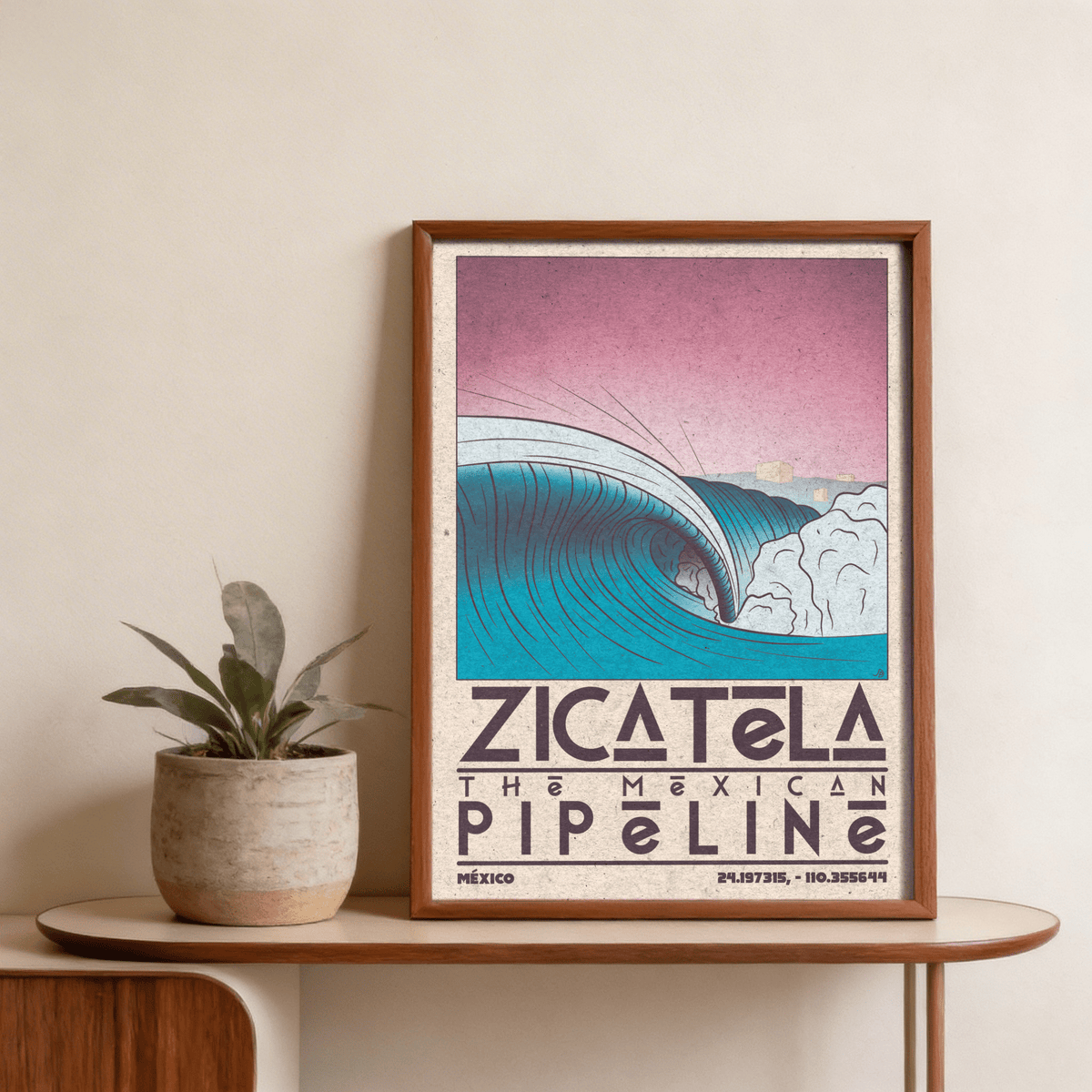 Framed Mexican Beach Art of a vintage ocean wave with blue and pink tones above a small plant