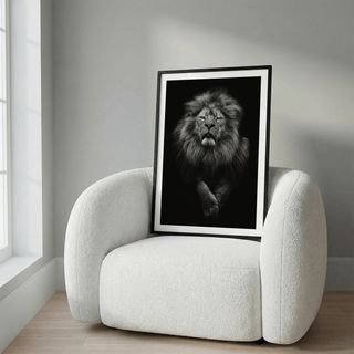 Black Lion Art Print leaning on a white armchair showing a monochrome lion portrait