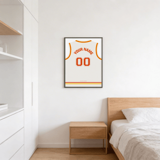 Basketball Jersey Poster in White with Red and Yellow Trim above a wooden bedside table in a bedroom