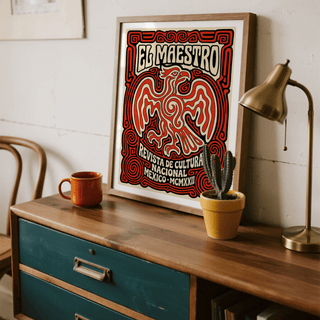 Framed Cultural Mexican Poster leaning on a wooden sideboard with red and beige eagle illustration and a cactus plant