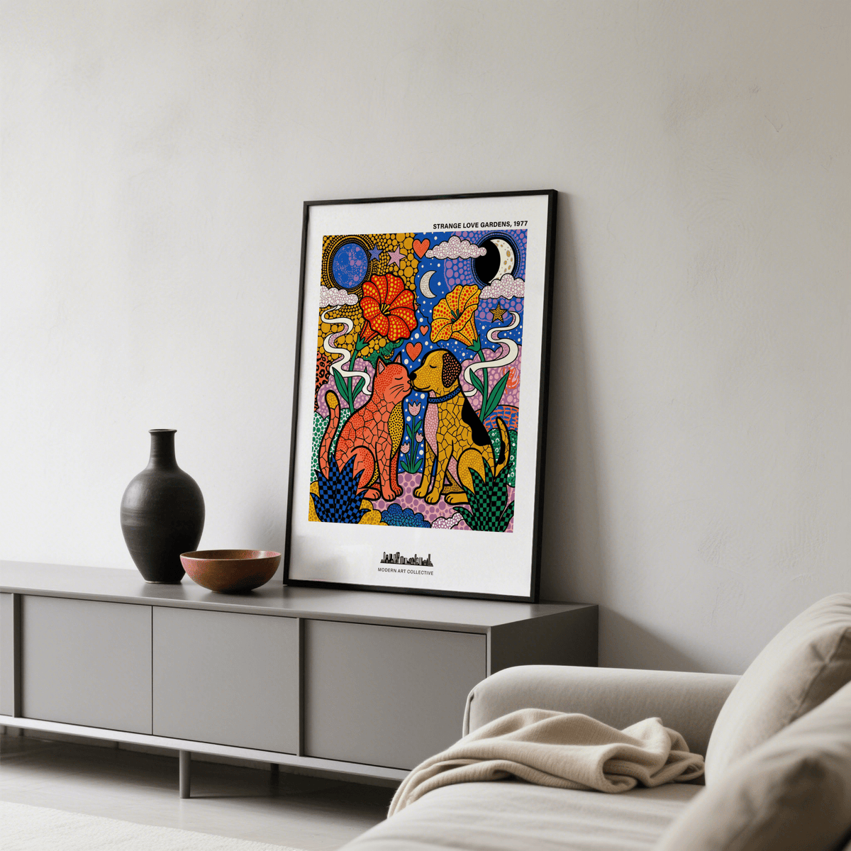 Print leaning on a sideboard of colorful animal art print with cat and dog in pop-art style and decorative objects
