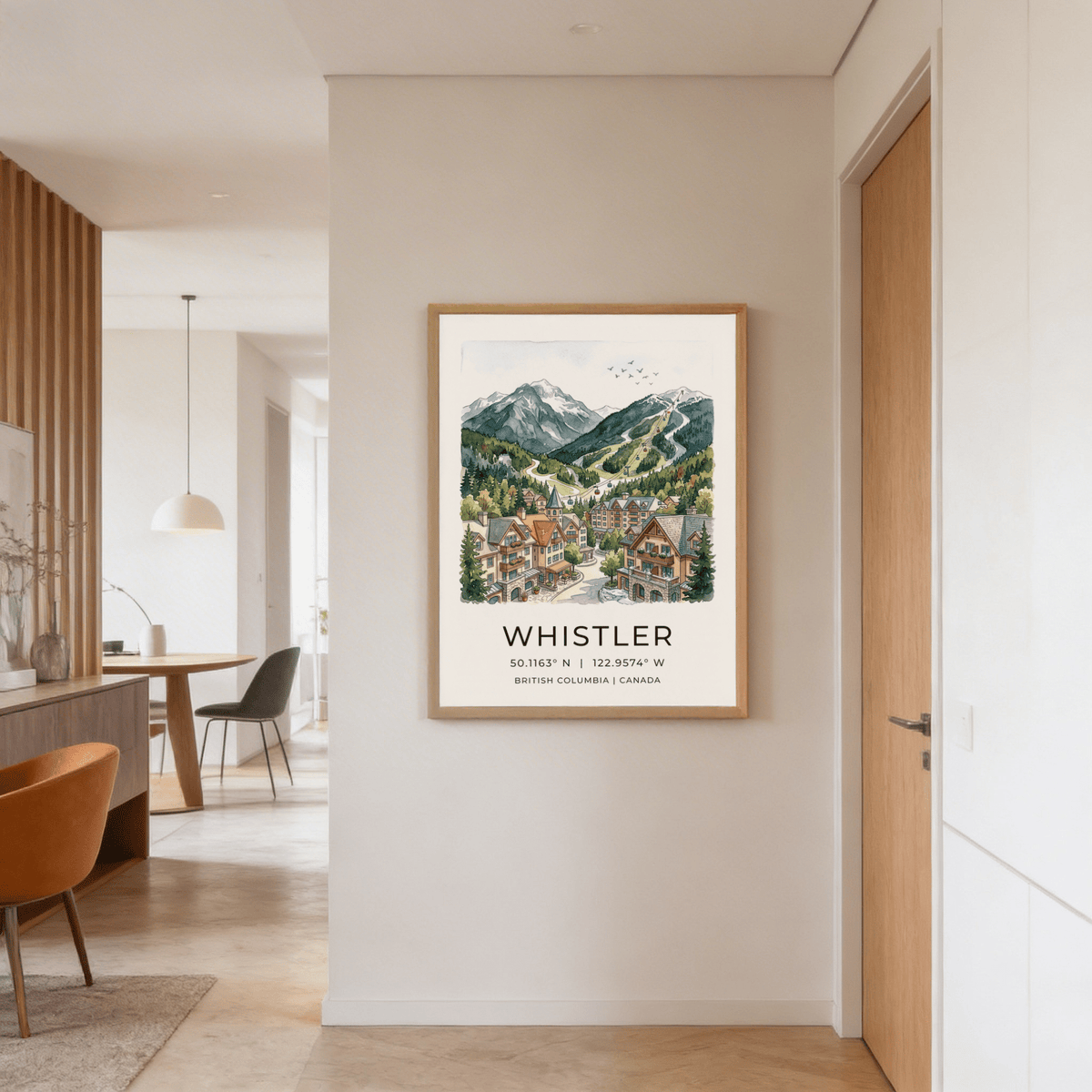 Whistler Mountain Print hanging on a pale wall showing a detailed watercolour mountain village scene in soft greens and browns