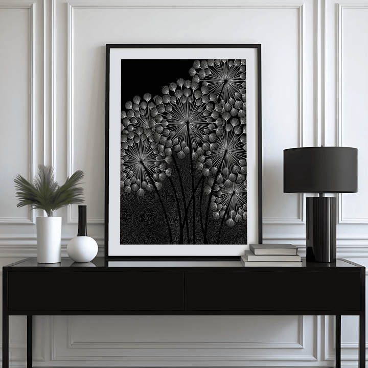 Dandelions wall art in black frame with white dandelion seed heads on black above a black sideboard
