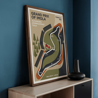 Framed Imola Circuit Map Poster leaning on a wooden surface with a small black vase nearby