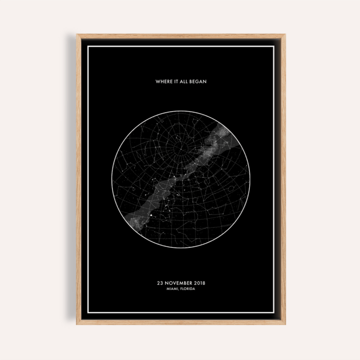 Framed Custom Star Map with minimalist black and white design on a pale wall