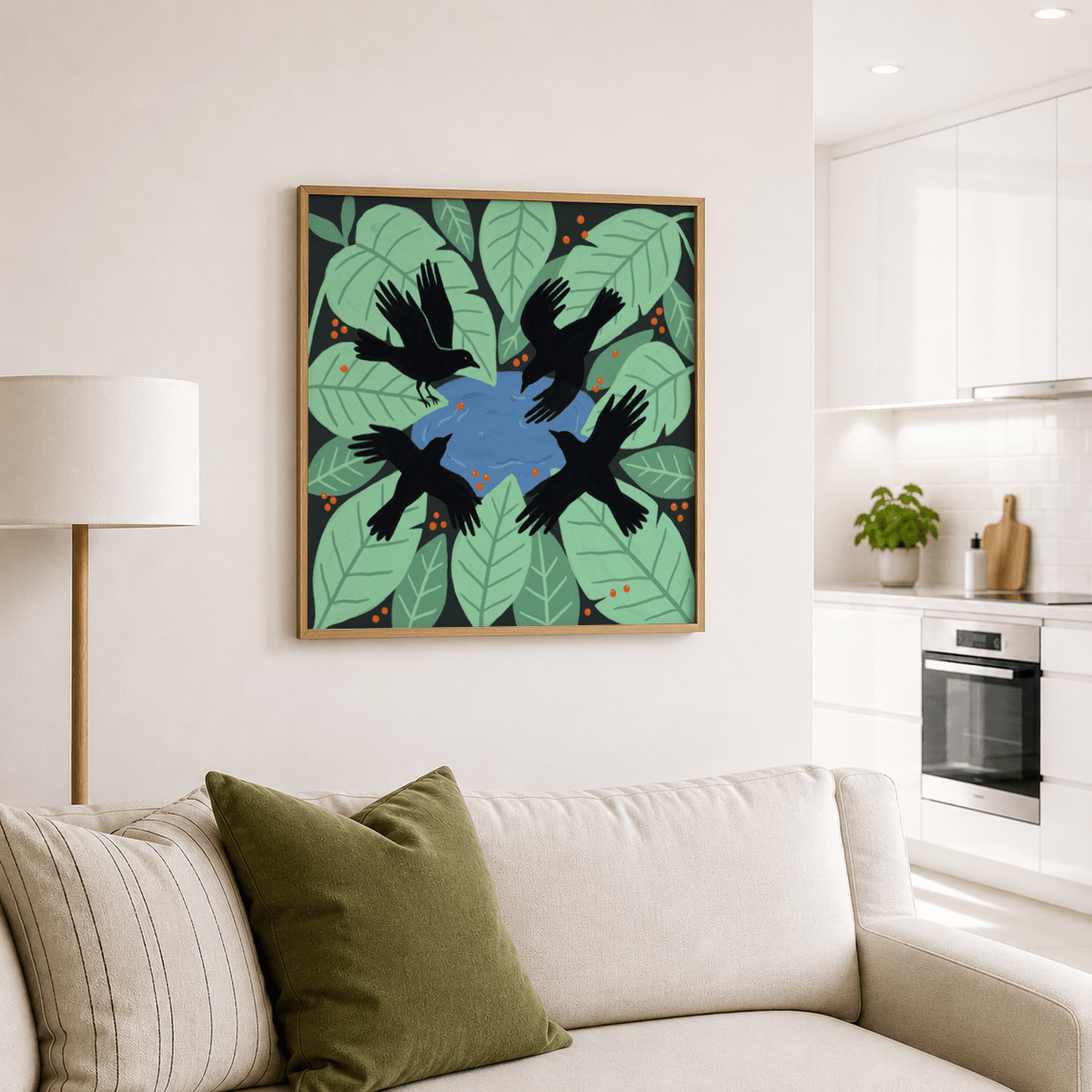 Crows art print leaning on a cream wall above a sofa with green and cream cushions in a living room