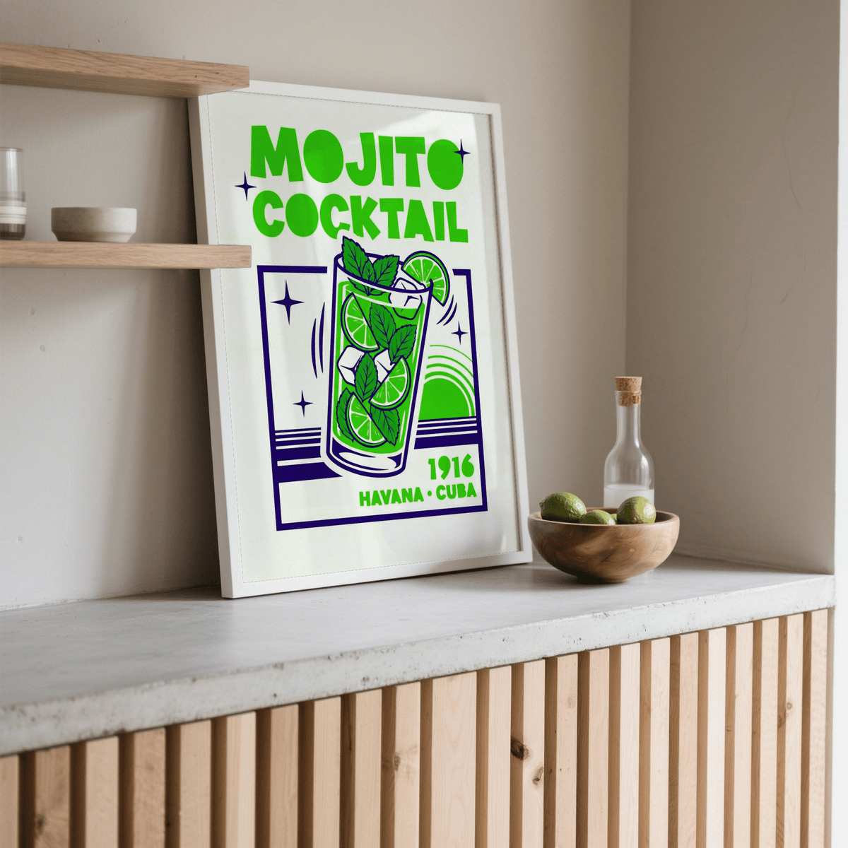Print leaning on a shelf mojito cocktail print in bright green and navy with a bowl of limes nearby