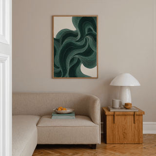 Wavy Poster with abstract wavy green lines above a beige sofa and wooden side table