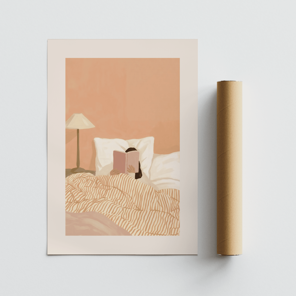 Woman Reading Book Art print with warm beige and soft pink tones shown alongside a packaging tube