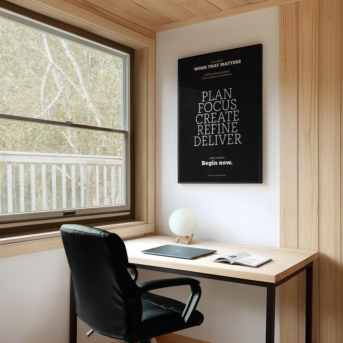Inspiring wall decor framed print with motivational text in black and white in a wooden study space