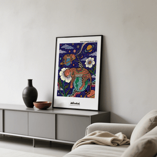Leopard Galaxy Art Print leaning on a surface with a dark vase and bowl nearby in a modern room