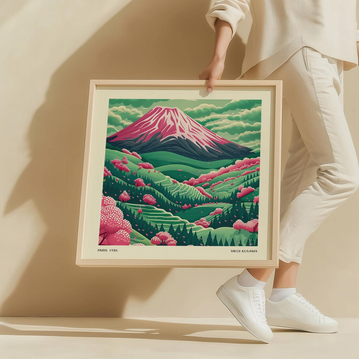 Framed Mountain Landscape Art with Mount Fuji and pink cherry blossoms held by a person