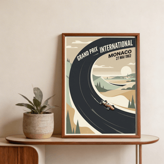 Framed print of the Vintage Car Racing Poster with beige and black minimalist design on a wooden shelf next to a plant pot