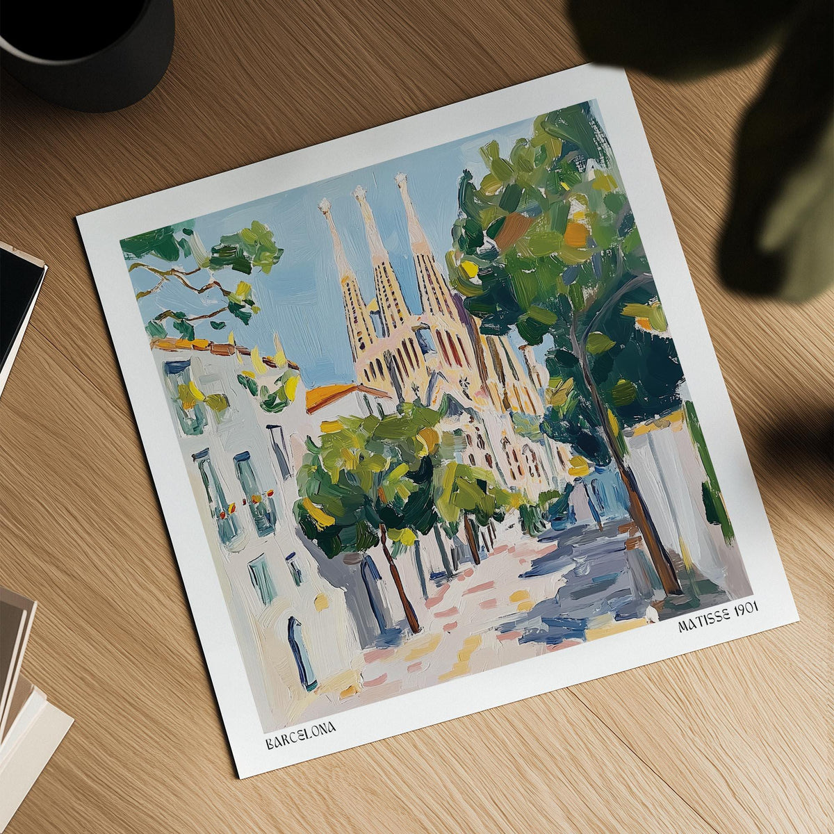 Barcelona Boulevard Poster showing a contemporary illustration of Sagrada Familia with green trees and blue sky on a wooden table