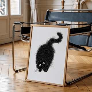 Arched Back Cat Print leaning on a modern black chair in a room with wooden floor