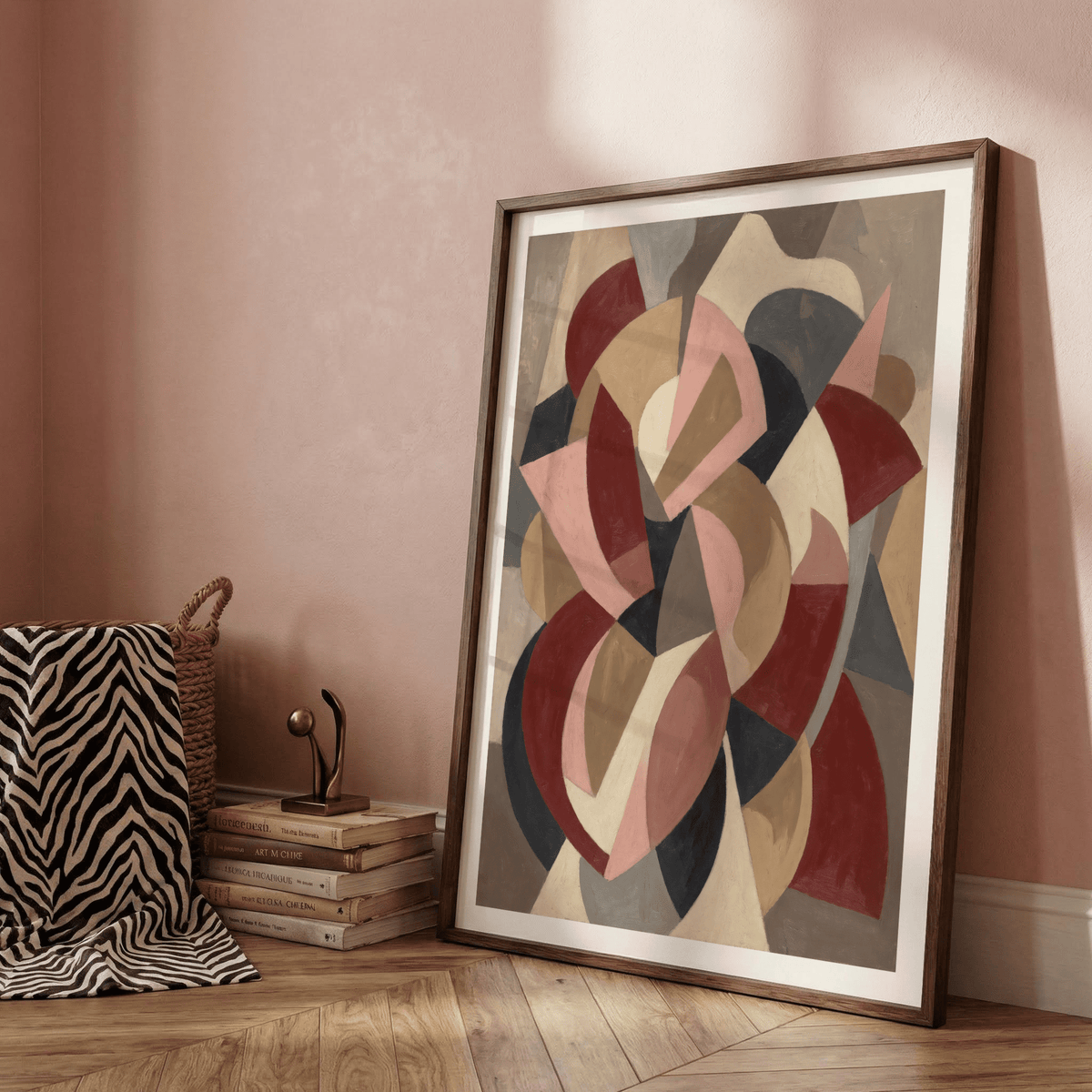 Minimalist Abstract Wall Art leaning on a wooden floor with a stack of books and a small sculpture nearby