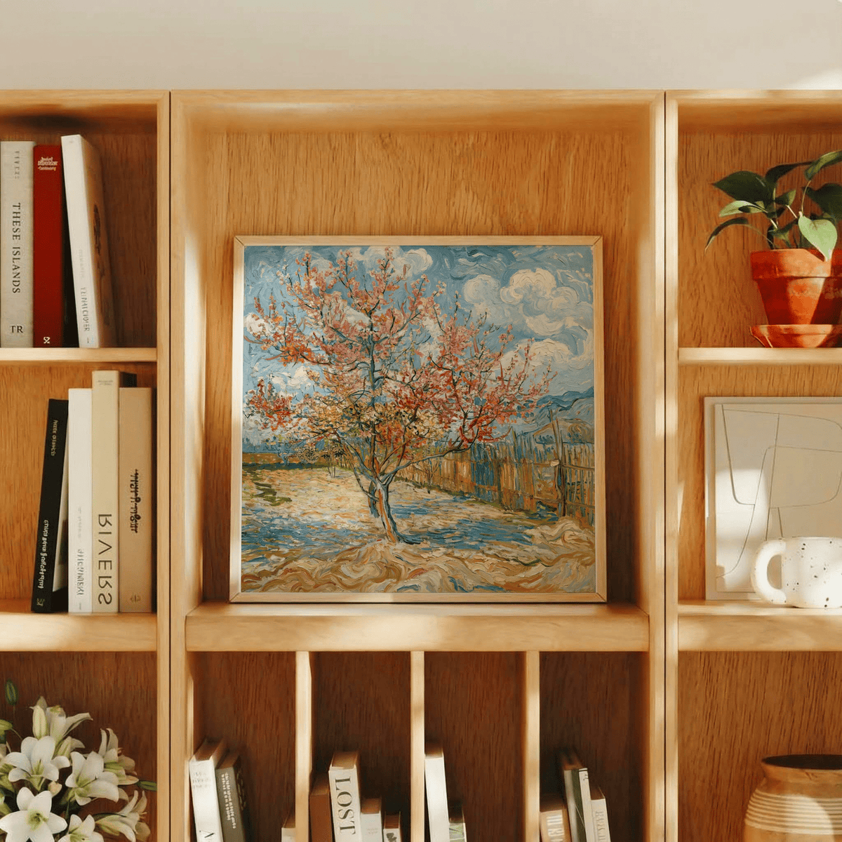 Spring Tree Art Print leaning on a wooden shelf surrounded by books and a plant