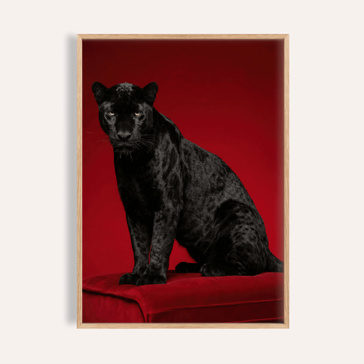Close-up of black panther art print showing glossy black fur and red background with wooden frame