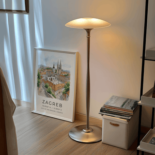 Print leaning with Zagreb City Art Print of watercolour cityscape near silver floor lamp and window