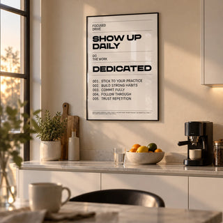 Daily Affirmations Print, framed on the wall of a modern kitchen at dawn with white cabinets and a warm beige wall