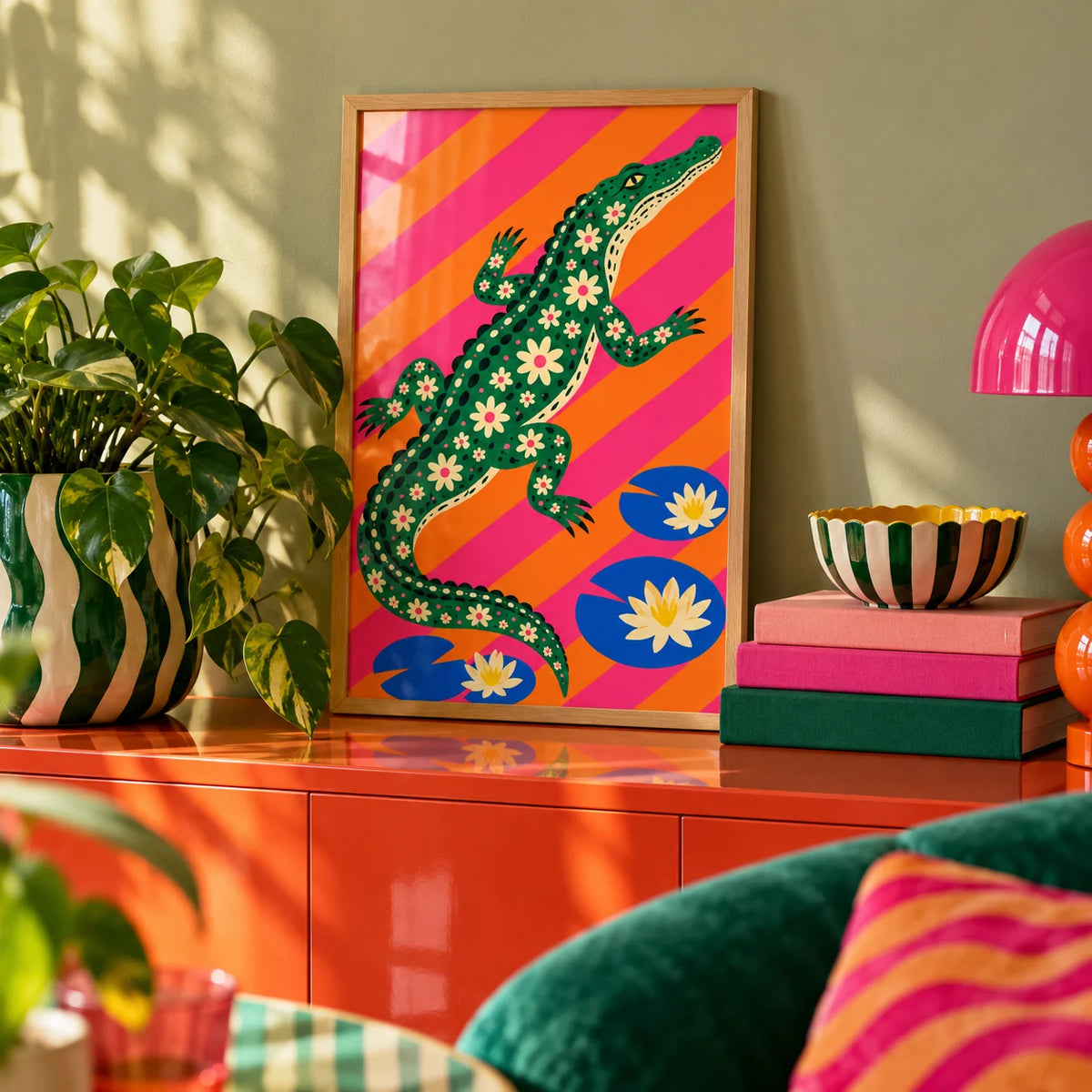 Daisy Crocodile Print, a small A4 framed print leaning on a colourful lacquered shelf in a living room