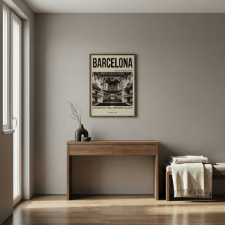 Print on a wall in a room showing Barcelona Concert Hall Poster with black and white interior and typography above a wooden desk