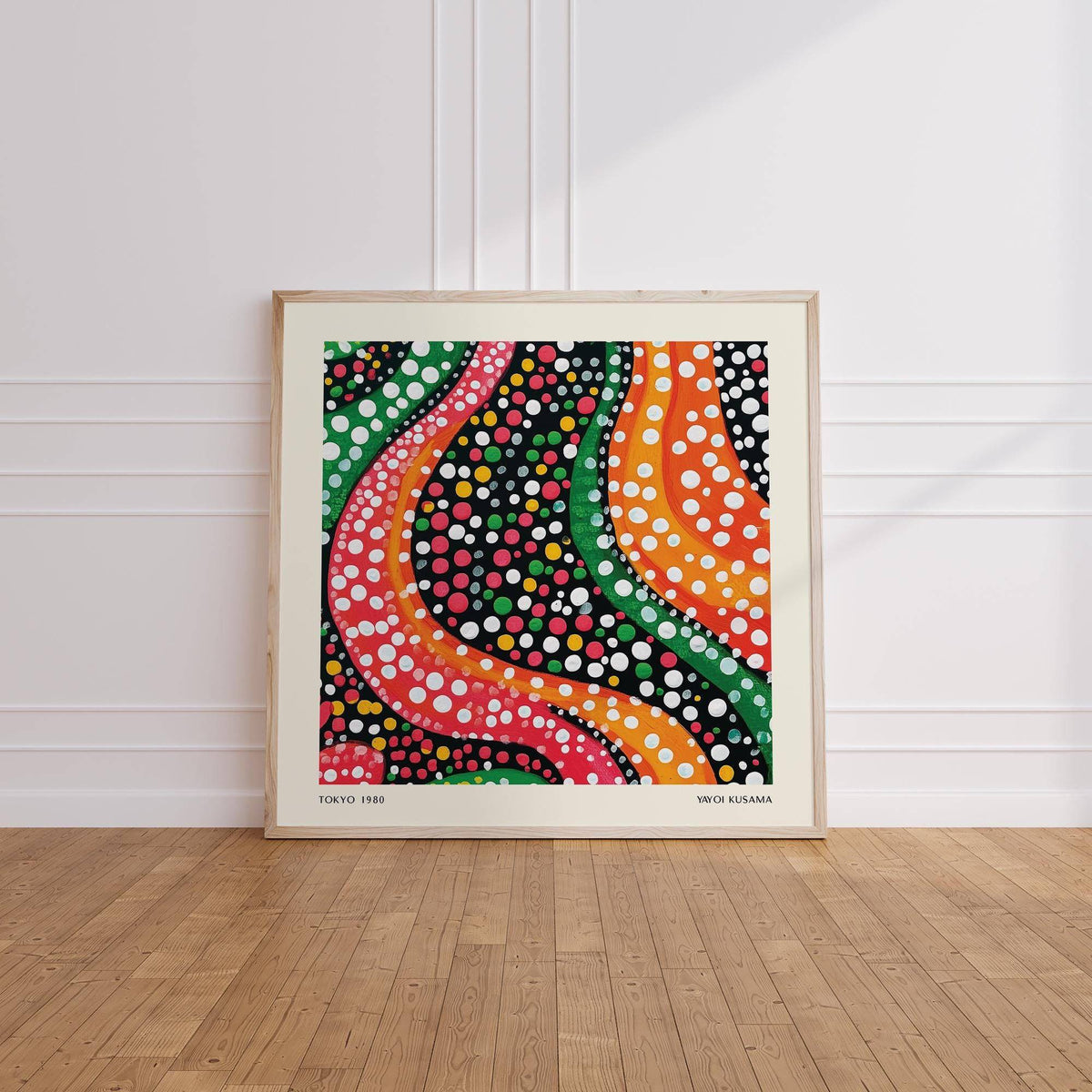 Abstract colorful art print with wavy lines and dots leaning on a wooden floor