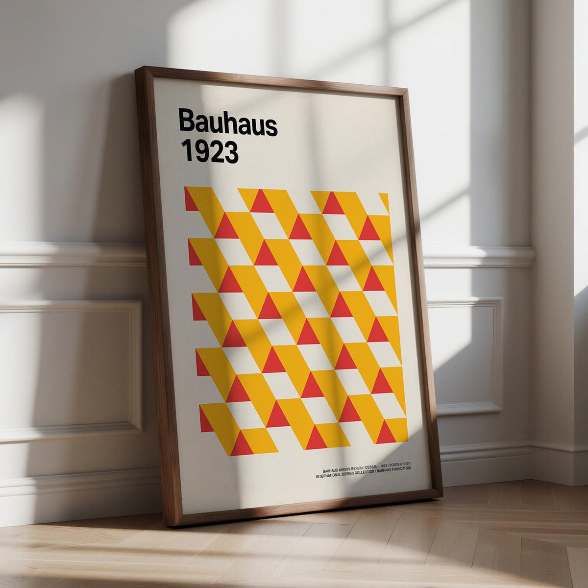 Art Posters Gallery print leaning on floor showing geometric triangles pattern in yellow and red