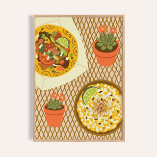 Framed Taco wall art showing a taco and corn dish with two small potted plants