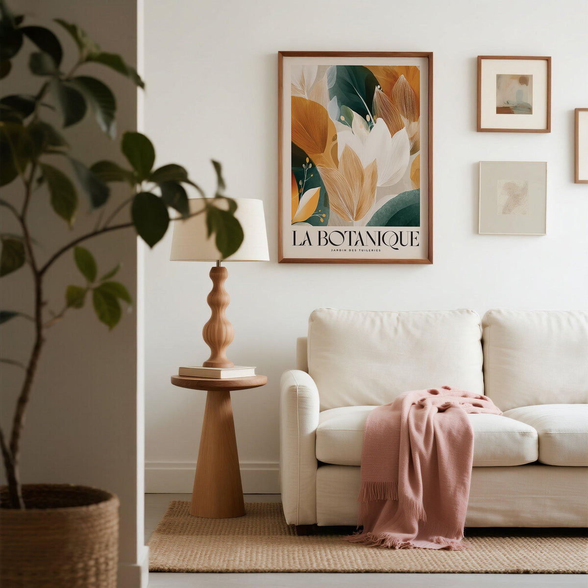 Wall Art with Leaves framed print of abstract botanical foliage in warm shades above a sofa with a pink throw