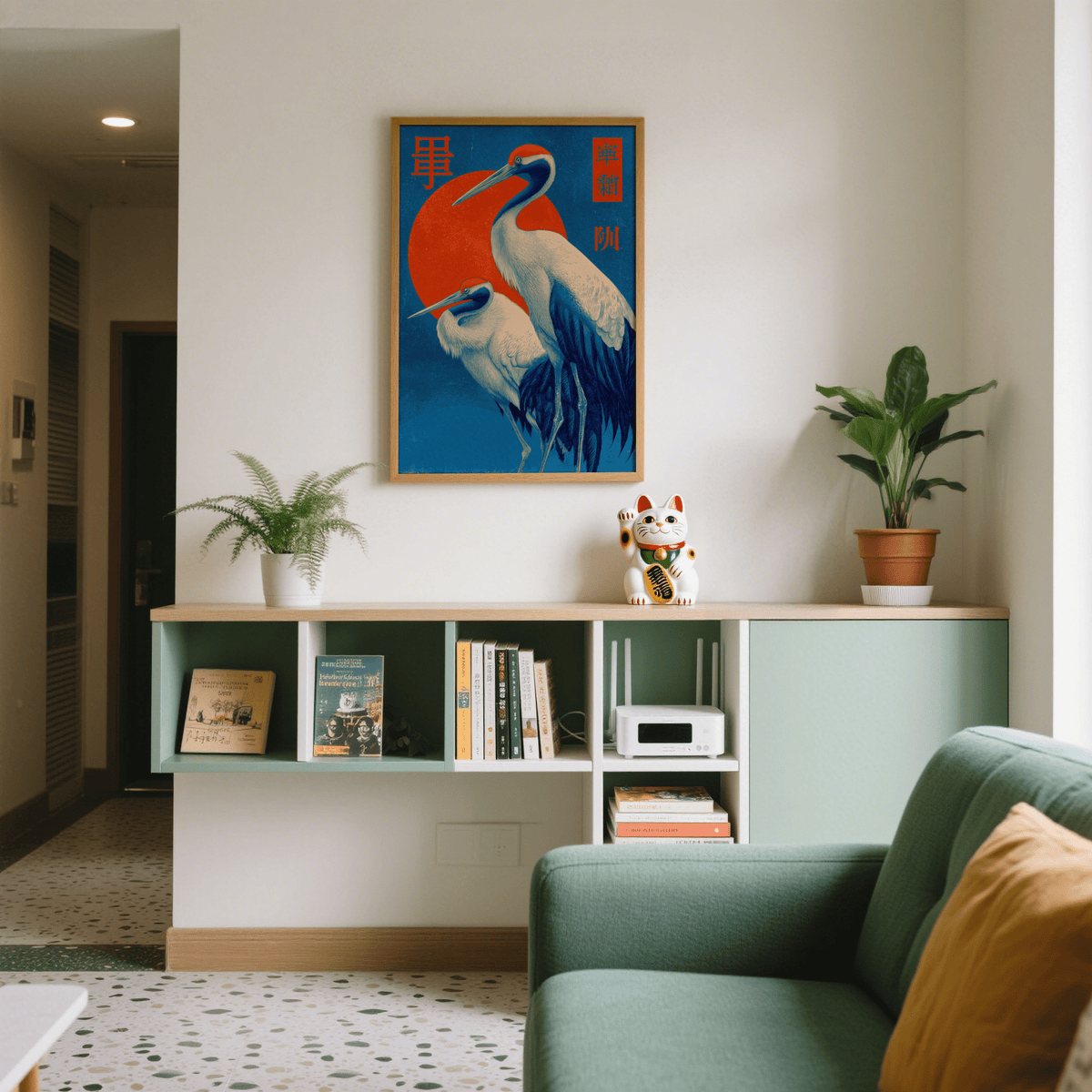 Cranes Art print on a wall above a shelf with books and a cat figurine in a modern room