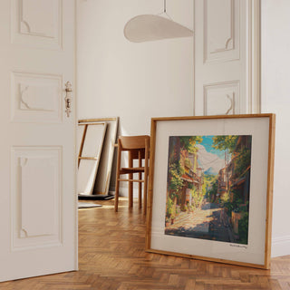 Print leaning on a floor with warm tones depicting a street view of Mount Fuji in vibrant colours