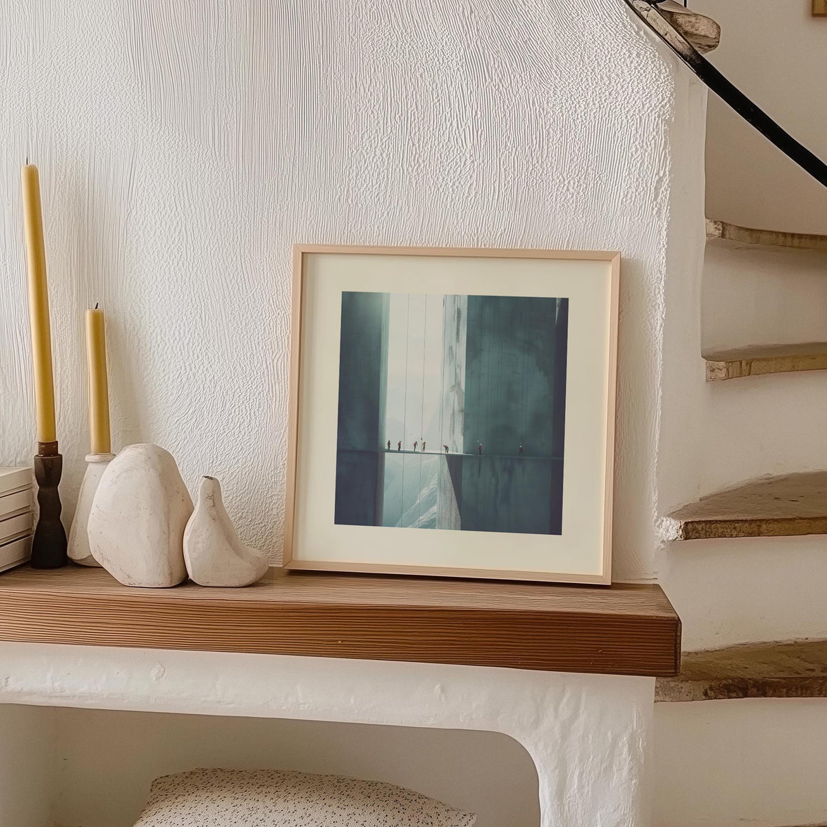Surreal Art Prints leaning on a shelf showing minimalist rope climbers in grey with neutral decor and candles