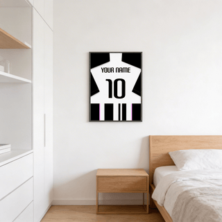 Football Shirt Poster in Black and White Stripes with Pink Accents on a bedroom wall above a wooden bedside table
