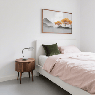 Autumn Tree wall art of orange trees and grey mountains above a wooden bedside table in a bedroom