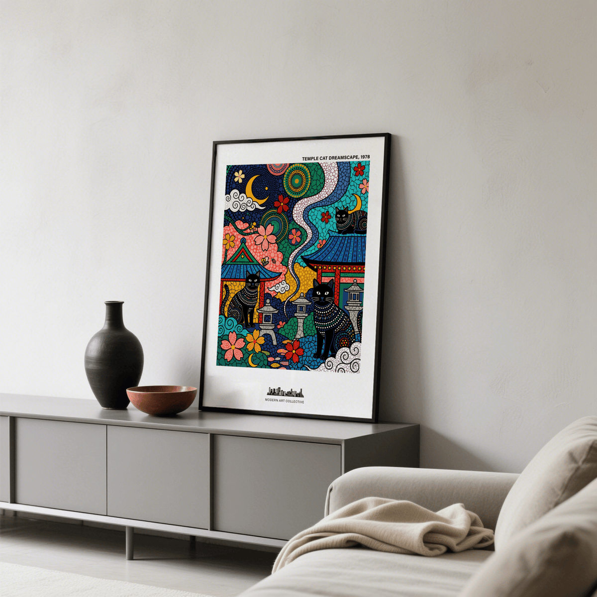 Japanese Cat Wall Art print leaning on a grey sideboard with brown pottery in a living room