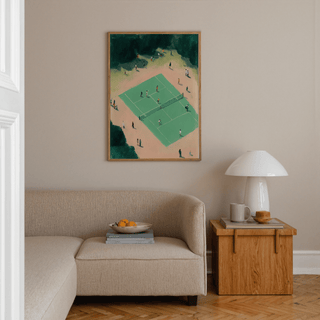 Tennis Court wall art above a beige sofa with a wooden side table and lamp