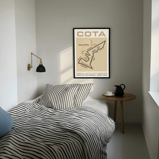 Race Track Map Poster framed print with circuit layout and beige tones in a bedroom above a round side table