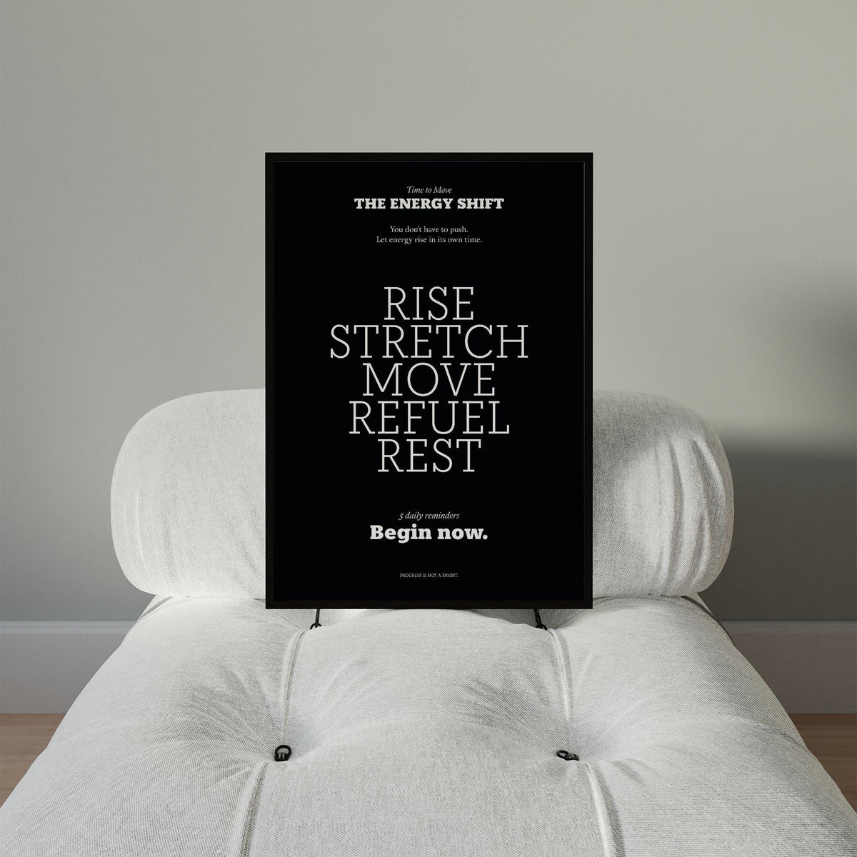 Motivational Posters with Quotes with white text on black background on a white cushioned chair