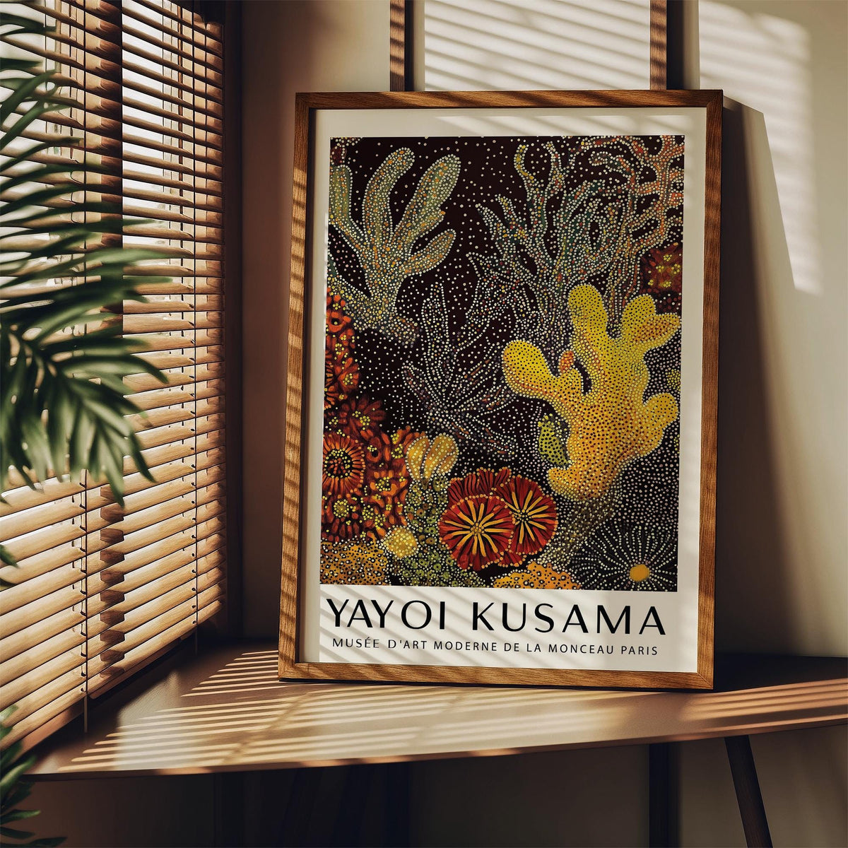 Coral Reef Art Abstract print with yellow coral shapes and dots leaning on a wooden shelf near window blinds