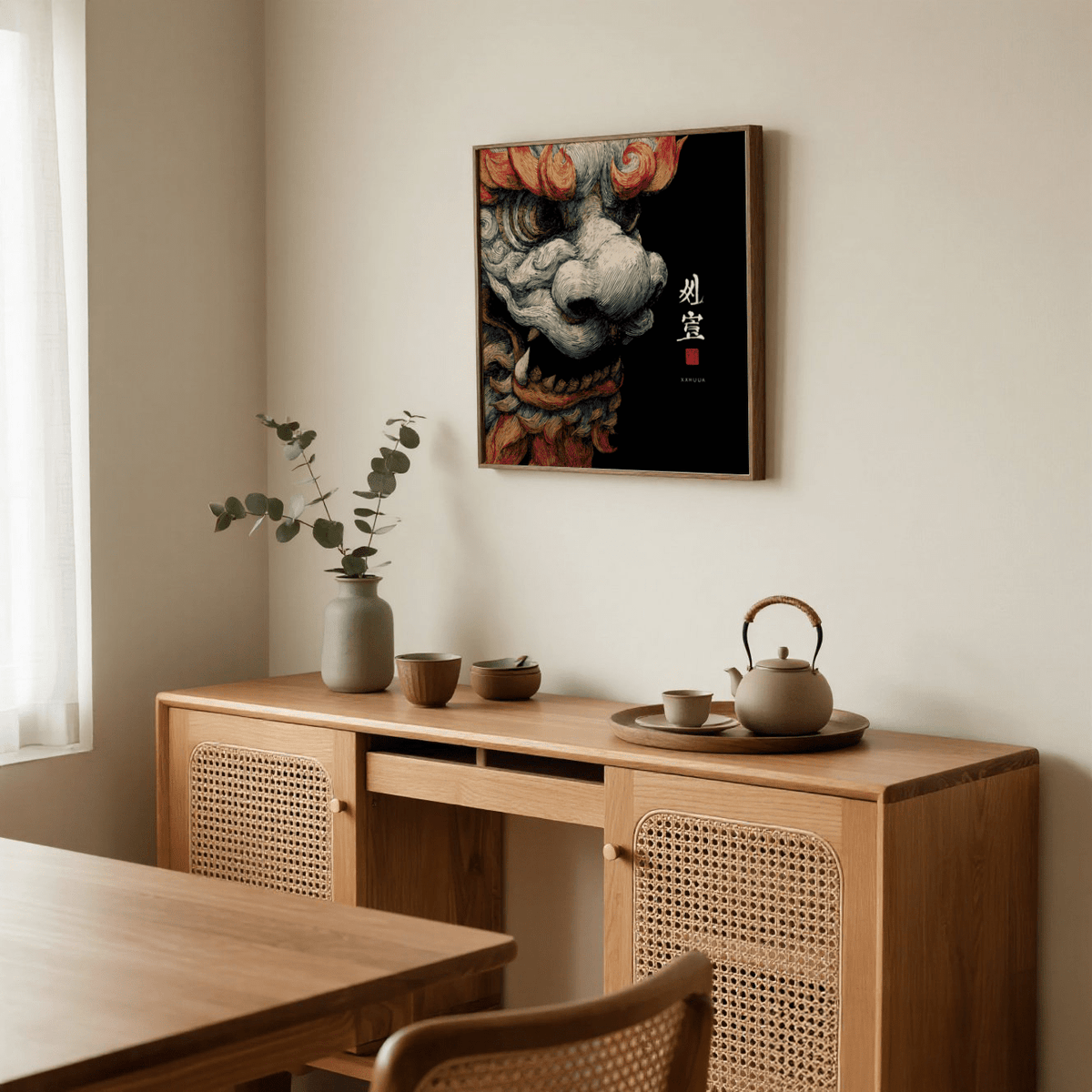 Shisa Print framed print close-up with dark background and red and grey tones above a wooden sideboard with pottery and a vase
