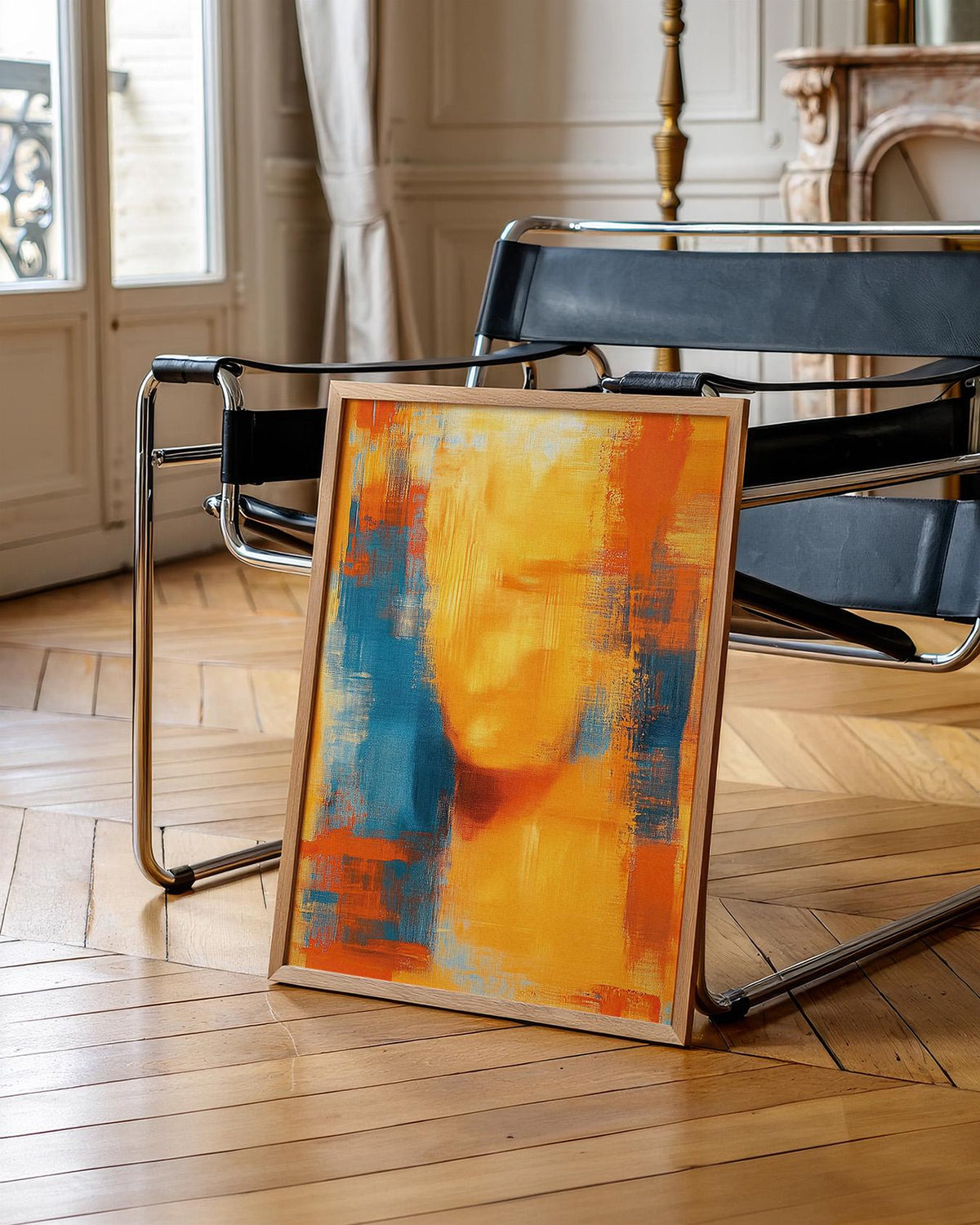 Blue and Orange Abstract Art print leaning on a modern black and chrome chair on wooden parquet flooring
