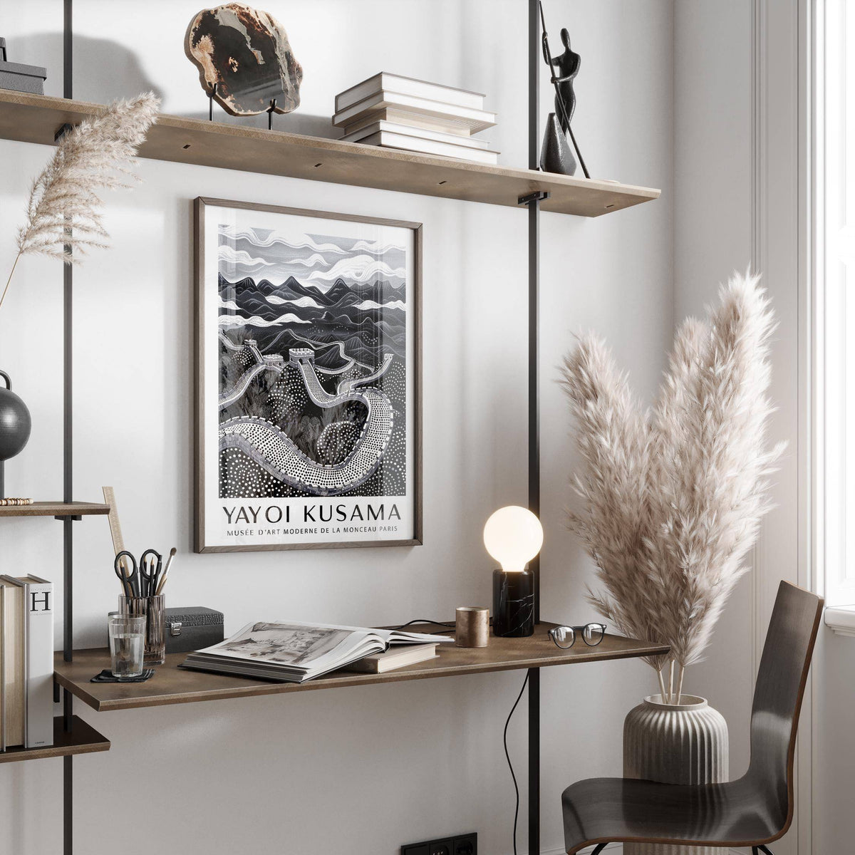 Chinese Wall Art framed print showing minimalist black and white Great Wall of China above a wooden desk with lamp and pampas grass