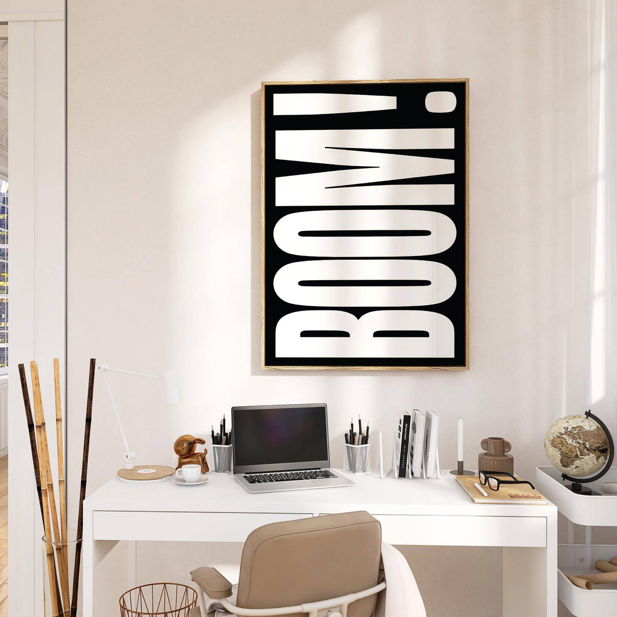 Modern Typography wall art with white boom typography on black in a bright office with a globe on the desk