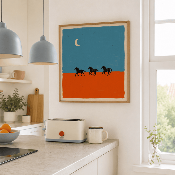 Horse silhouette wall art with three running horses on blue and orange background in a kitchen above a toaster