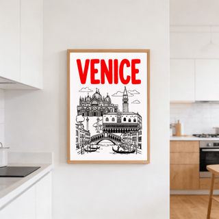 Venice Landmark Art Print hanging in a kitchen with white and wooden cabinets and a stove