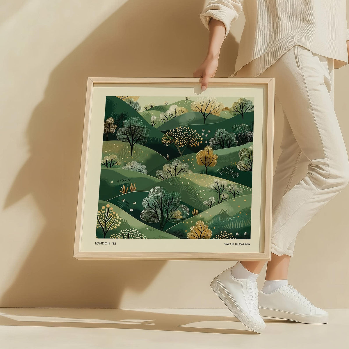 Large Nature Wall Art held by person showing green hills with trees illustration in wood frame