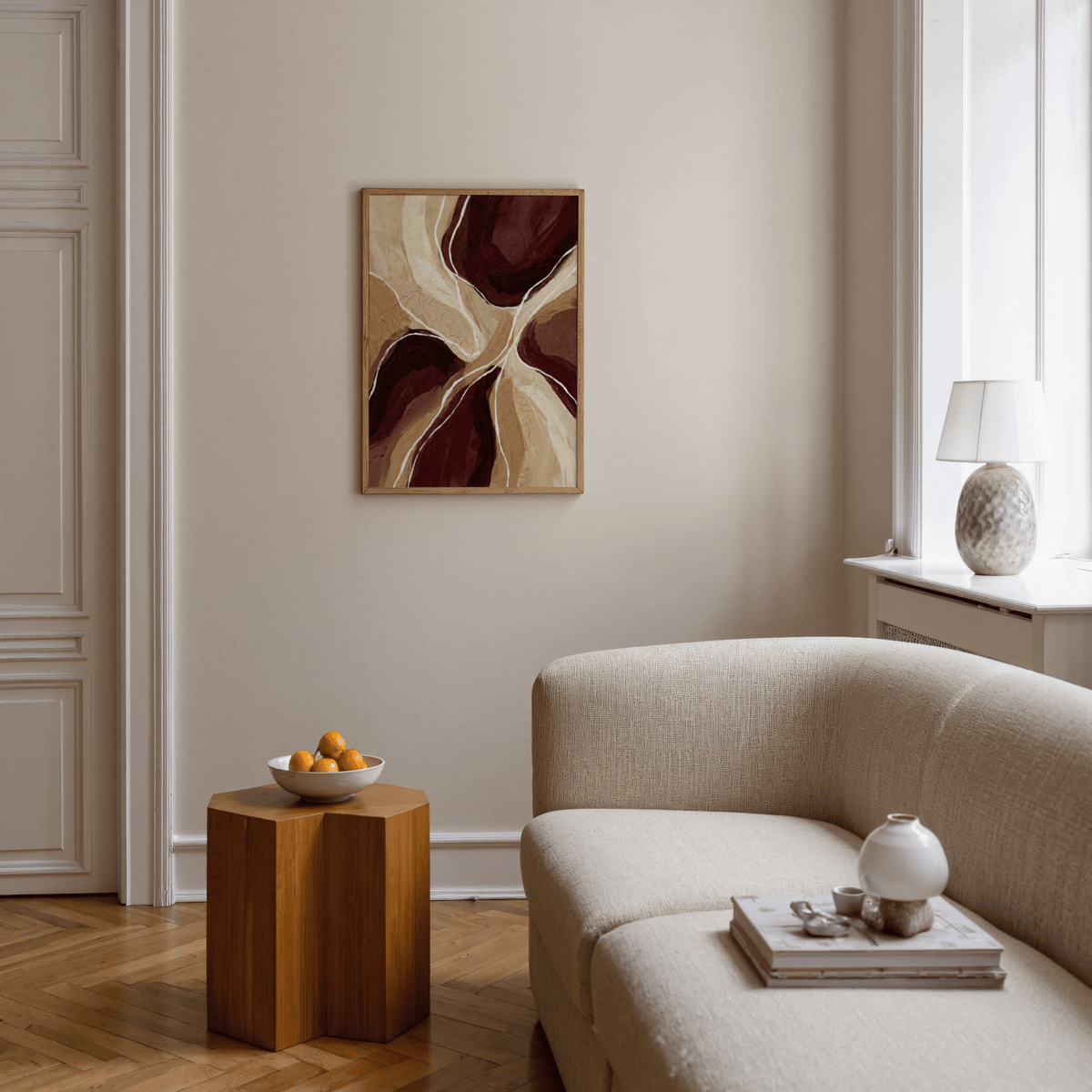 Organic Abstract Art Print framed print in brown and beige tones above a wooden side table with a bowl in a living room